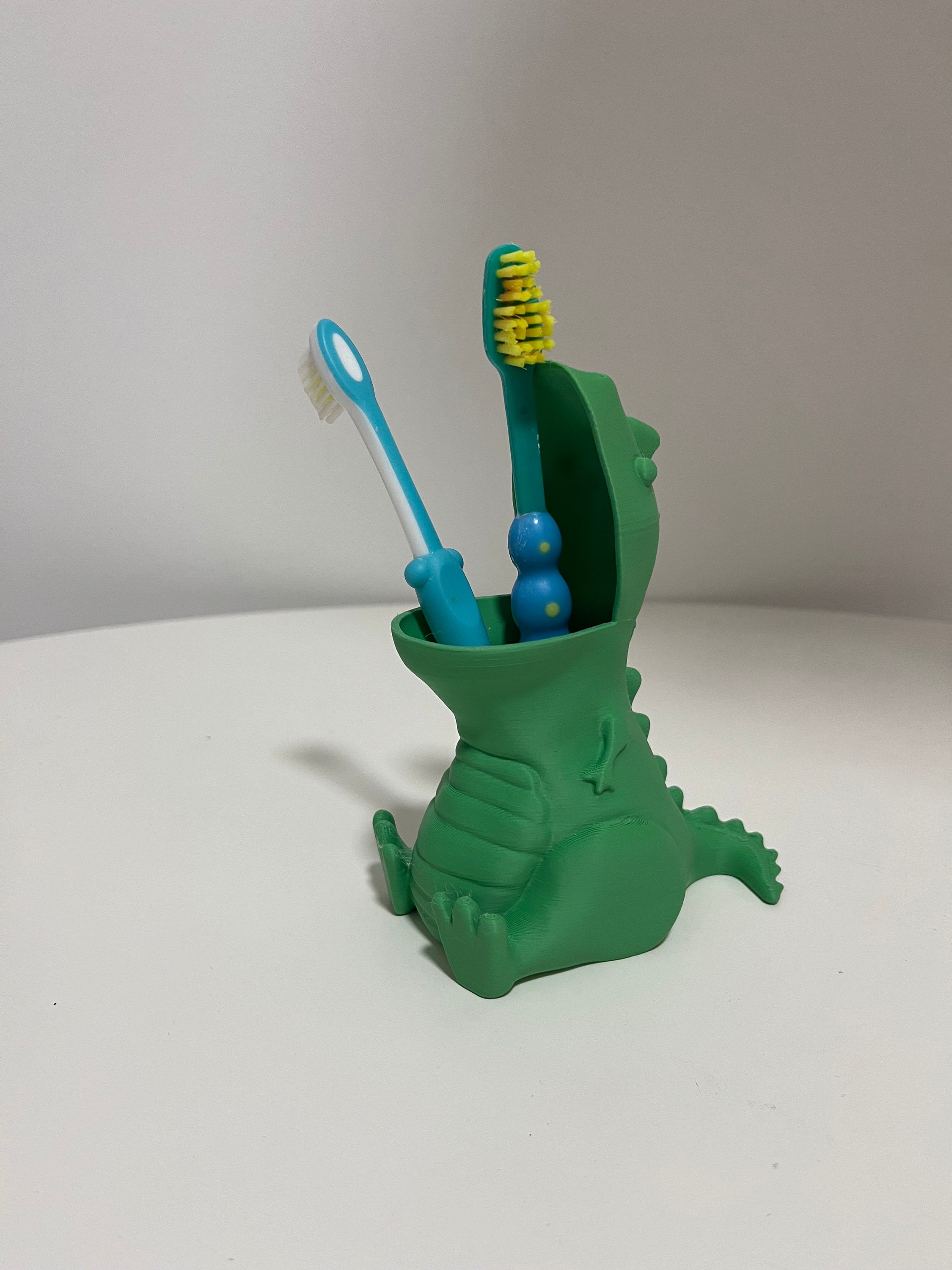 Dinosaur toothbrush holder