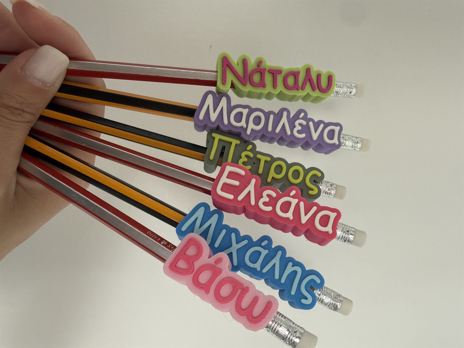 Close-up of personalised name pencil toppers made in Cyprus